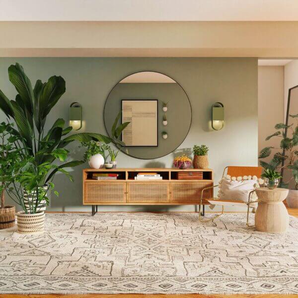 Mid-century modern, boho living room with plants, large round mirror, and natural wood furniture